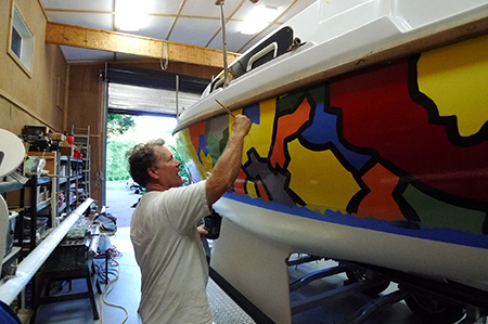 Artist Bill Barnhart adds finishing touches tothe crazy topsides.