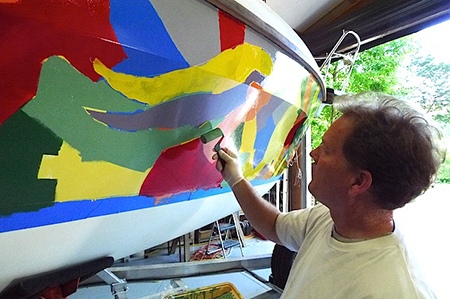 Artist Bill Barnhart adds finishing touches tothe crazy topsides.