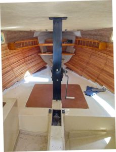 The V-berth is insulated, lined with cedar, and fitted with shelving.