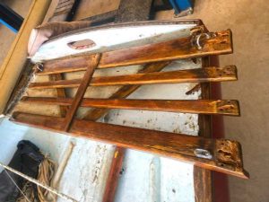 The slatted rear deck had some rot in every piece, but the hardware was salvaged for later use.