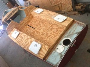 the centerboard being reinforced. The connection was loose, so the author wrapped it with fiberglass and additional uniaxial carbon fiber strips set in epoxy.