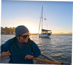 the author’s partner, Chris, rowing their Fatty Knees 8 in San Francisco’s Aquatic Cove.
