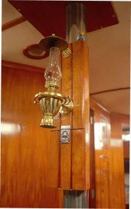 the teak box Chris and Marissa built does double duty, also providing a space to mount an oil lamp.