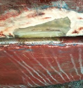 a bottom view of the centerboardopening, showing the extent of new fiberglass at the repair area.
