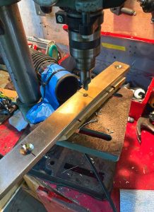 drilling the holes and countersinks in the bentchainplates. The vacuum tube taped to the drill press worked well to keep bronze shards in check.