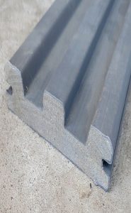 A strip of composite decking from HomeDepot was pre-cut with grooves that
could straddle the rungs of the ladder.