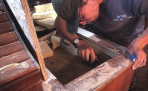Chipping out the old insulation and countertop was time-consuming but satisfying.