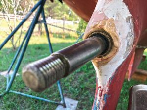 The new sleeve is installed over the shaft, with the cutlass bearing in place. The wet epoxy squeezed out, and the author was careful not to get it on the bearing.
