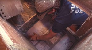 Positioning the Foamular XPS insulation in the bottom of the fridge compartment.