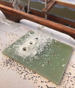 The backing plate forthe clutch, hot-glued
to the deck to provide a
template for precise hole
location, before and after
drilling.